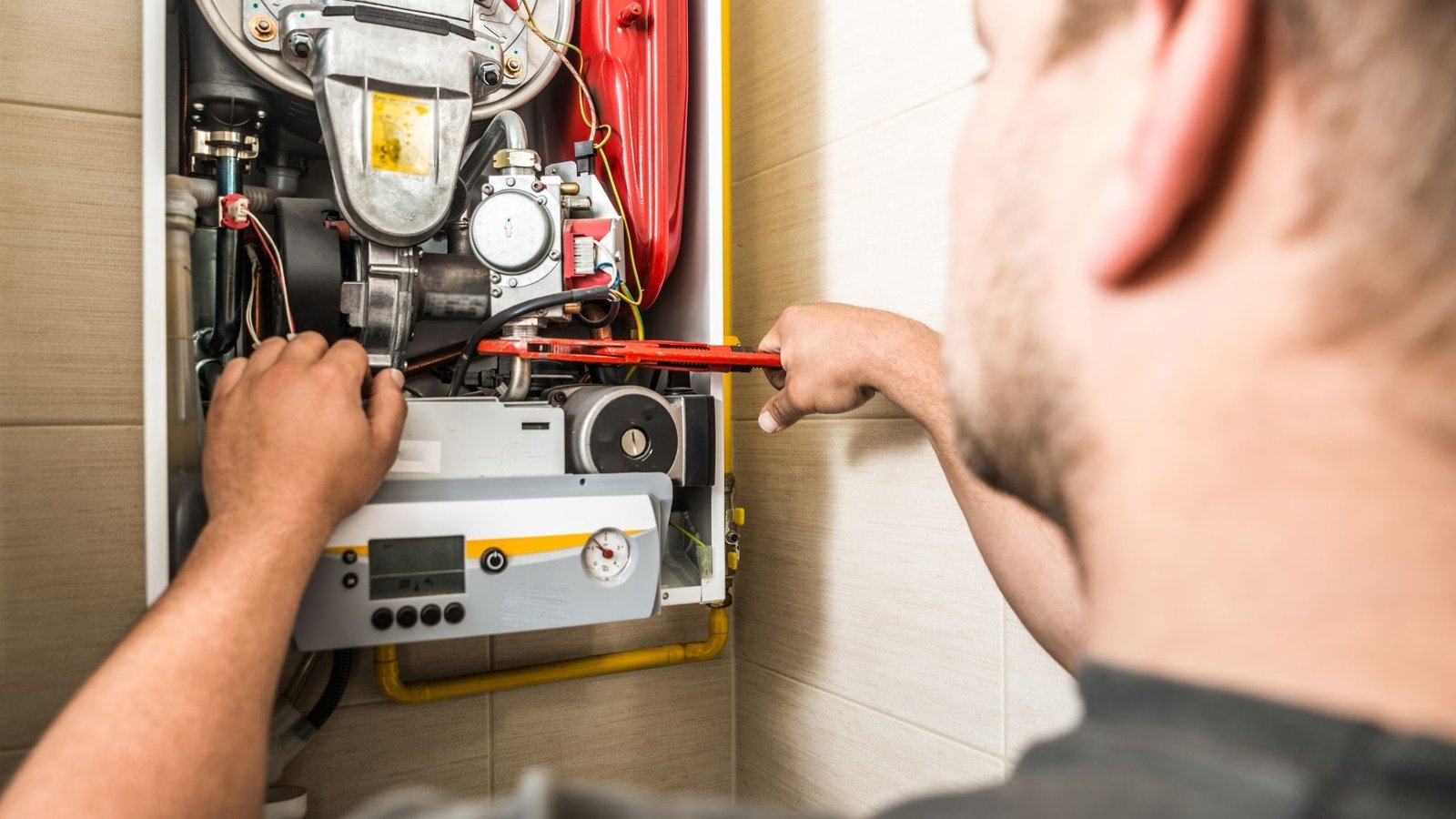 Furnace repair technician inspecting gas furnace